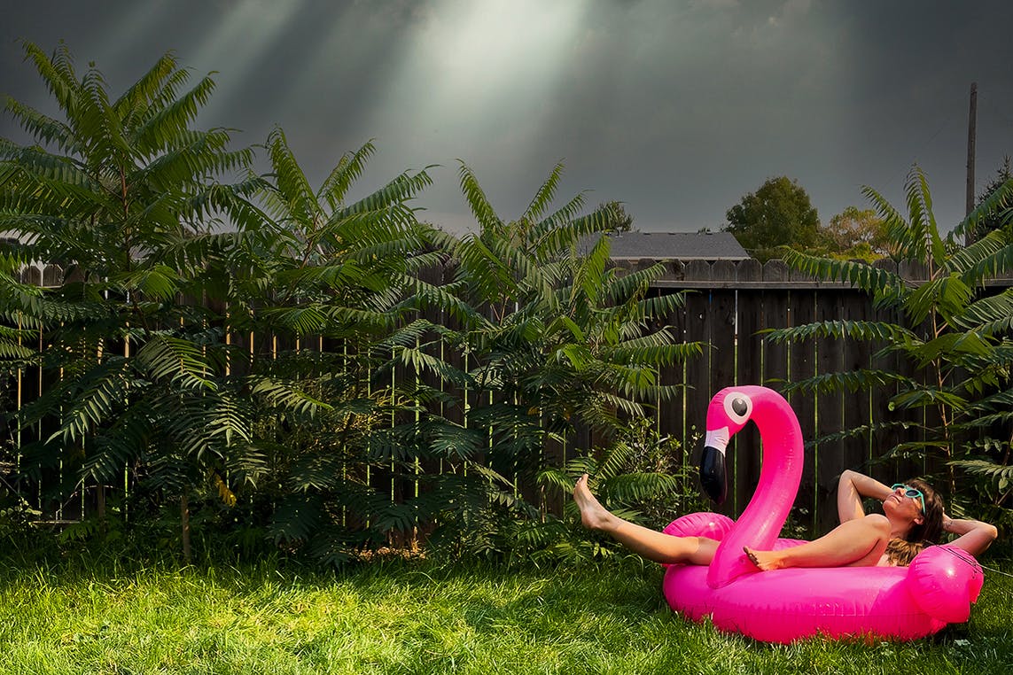 Emma on a flamingo floaty in the grass